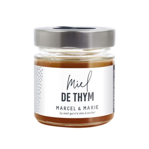 A jar of Marcel & Marie thyme honey named "Miel de Thym," featuring a sleek design with a silver lid and minimalist label.