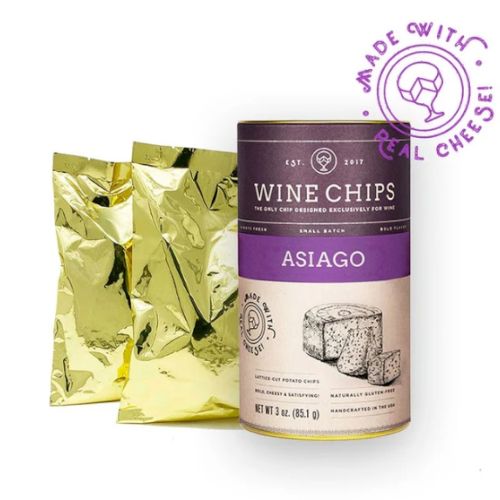 The image shows a container of Asiago flavored Wine Chips with two gold foil packets and a stamp indicating they are made with real cheese.